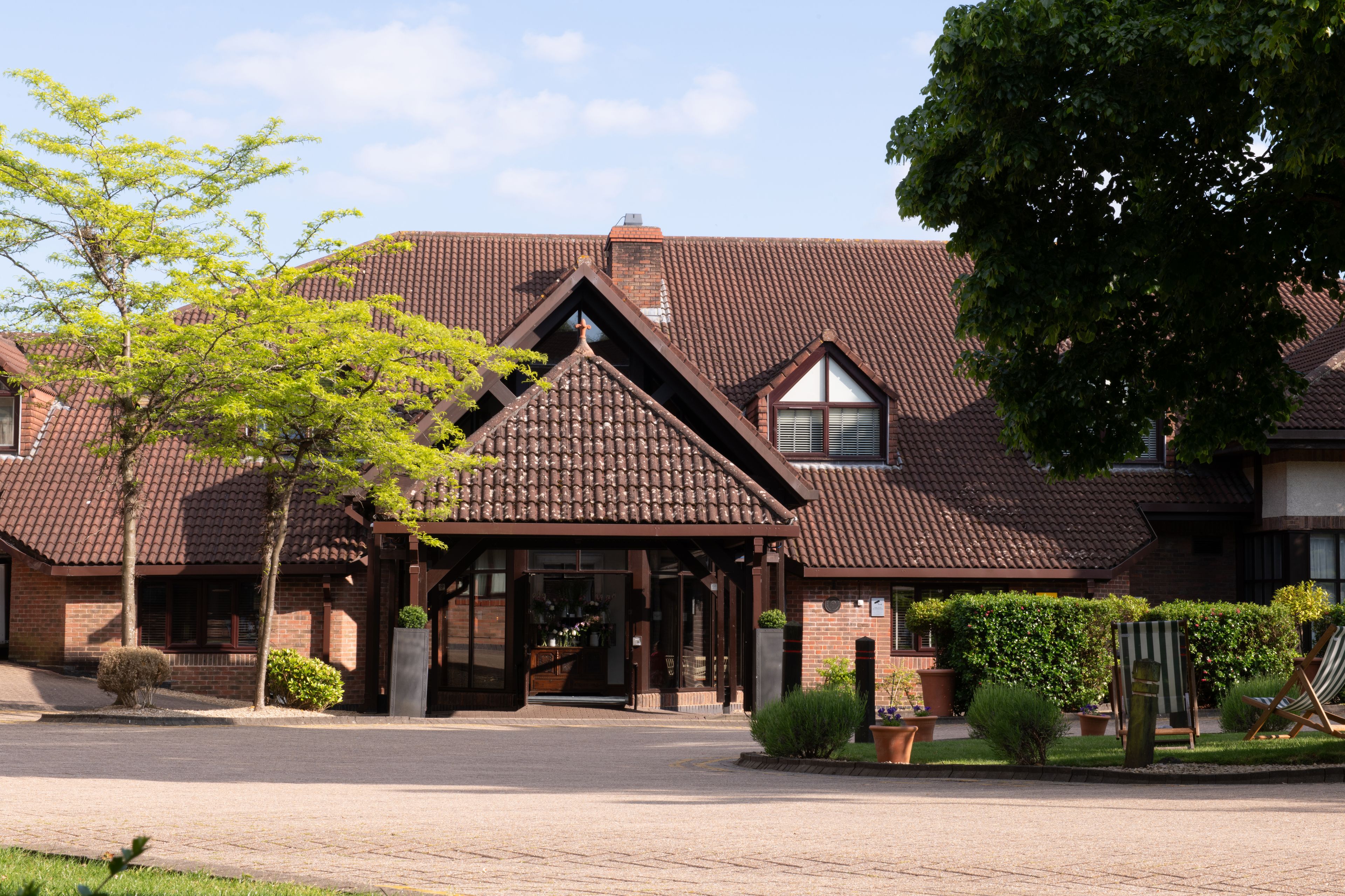 hotel entrance with brick facade and tiled roof