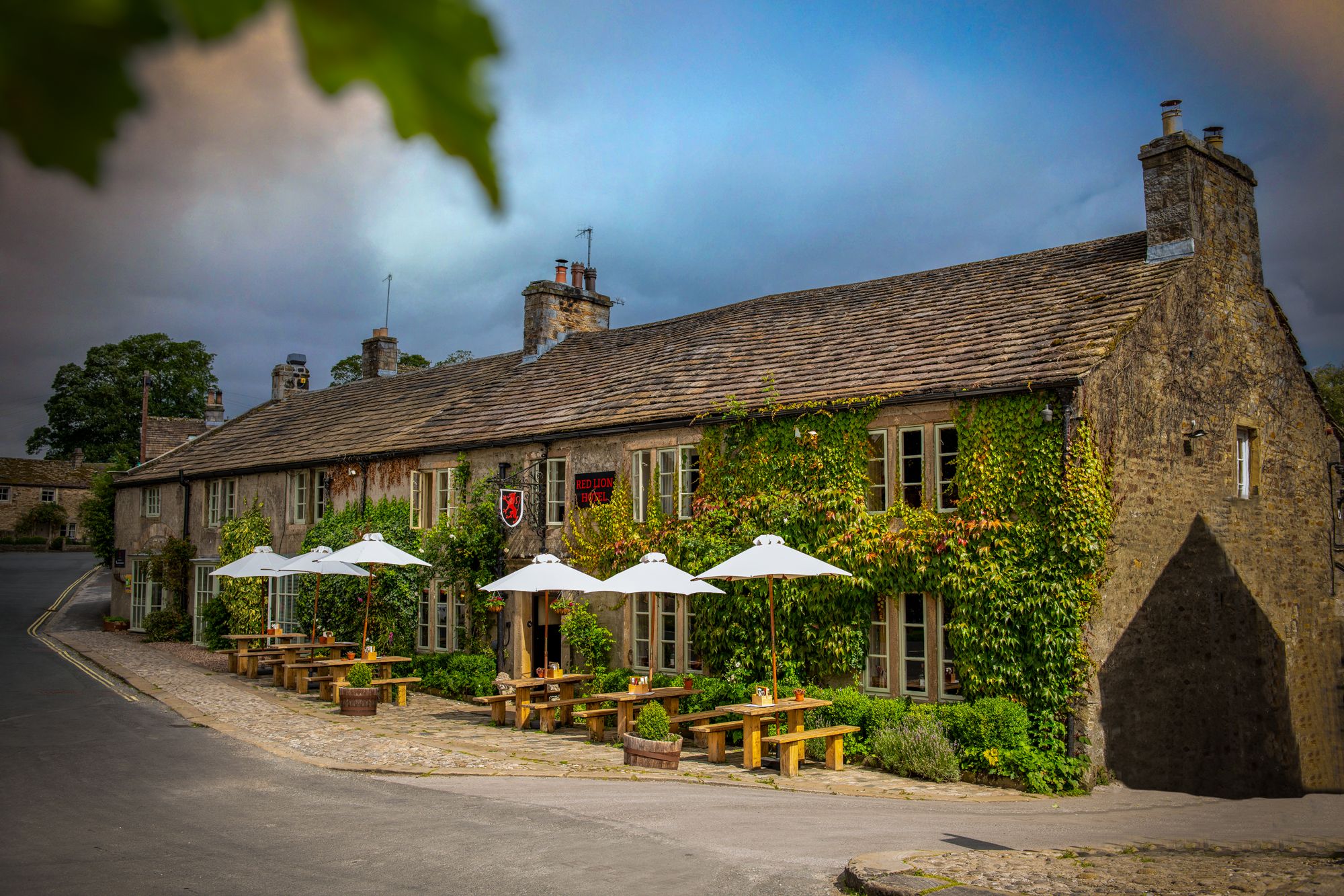 stone pub with outdoor seating and umbrellas